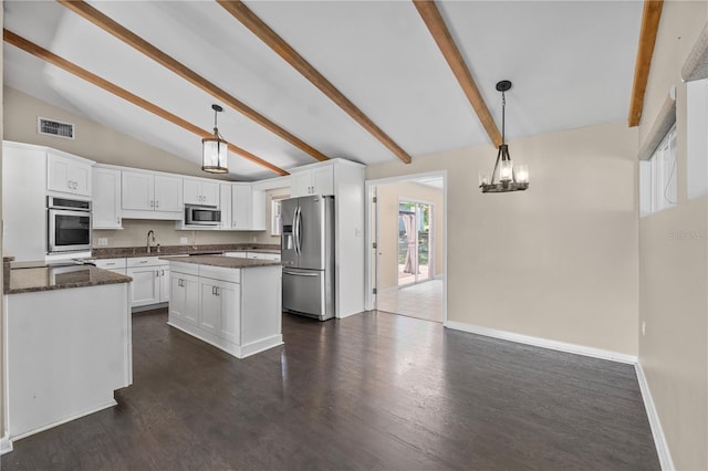 710 Carlton Ave, Lake Wales, FL 33853 - kitchen with stainless steel appliances, beam ceiling, white cabinetry, a sink, and dark stone countertops