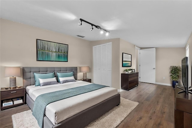 710 Carlton Ave, Lake Wales, FL 33853 - bedroom featuring rail lighting, wood finished floors, and baseboards