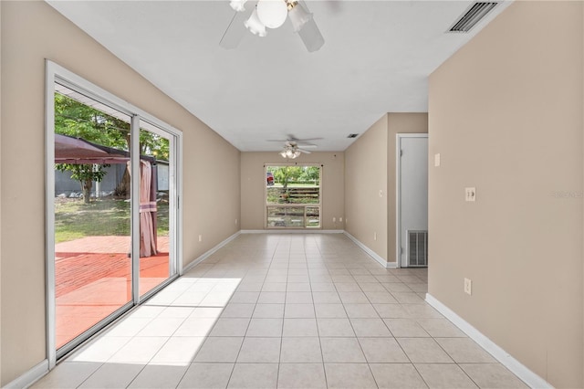 710 Carlton Ave, Lake Wales, FL 33853 - empty room with a ceiling fan, light tile patterned floors, and baseboards