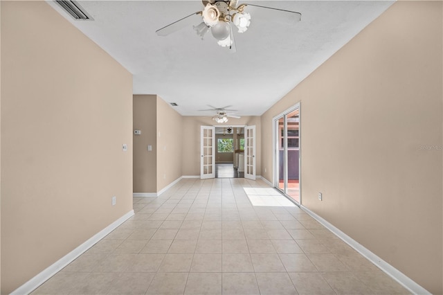 710 Carlton Ave, Lake Wales, FL 33853 - hallway with french doors, baseboards, and light tile patterned floors