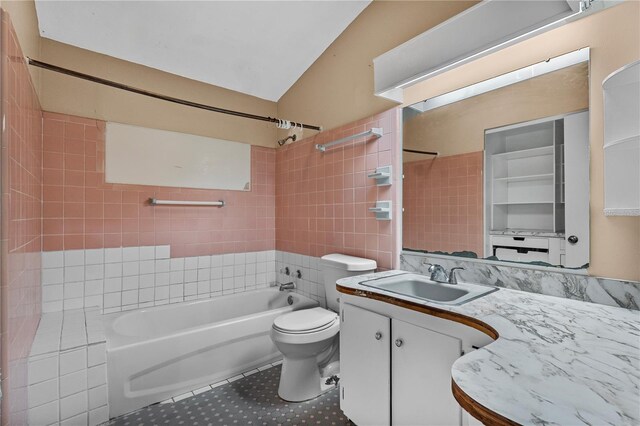 710 Carlton Ave, Lake Wales, FL 33853 - full bath featuring tub / shower combination, tile patterned flooring, vanity, toilet, and tile walls