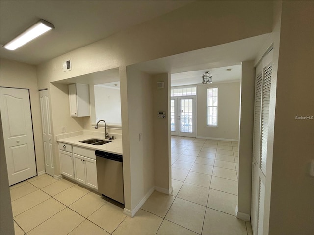1020 Siena Park Blvd W Unit 304, Kissimmee, FL 34747 - kitchen with stainless steel dishwasher, a sink, light countertops, and light tile patterned floors