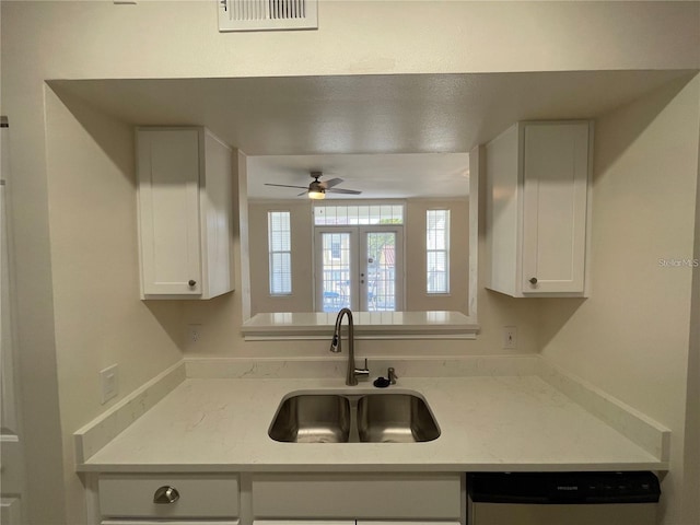 1020 Siena Park Blvd W Unit 304, Kissimmee, FL 34747 - kitchen with a sink, dishwashing machine, ceiling fan, and white cabinetry