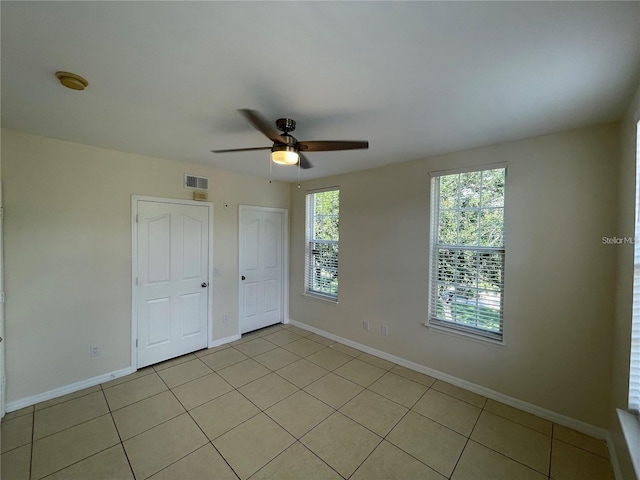 1020 Siena Park Blvd W Unit 304, Kissimmee, FL 34747 - unfurnished bedroom with light tile patterned floors, baseboards, and ceiling fan
