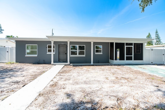 7014 Hershey Way, Orlando, FL 32822 - ranch-style house featuring a sunroom and a gate