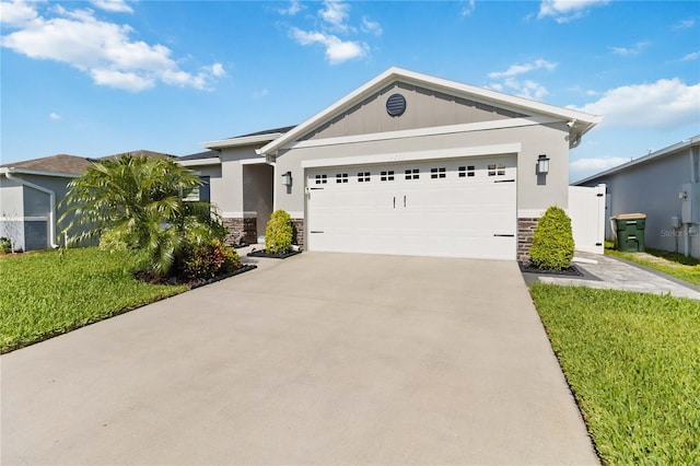 3211 Sweet Acres Pl, Saint Cloud, FL 34772 - ranch-style house with stone siding, a front yard, an attached garage, and driveway