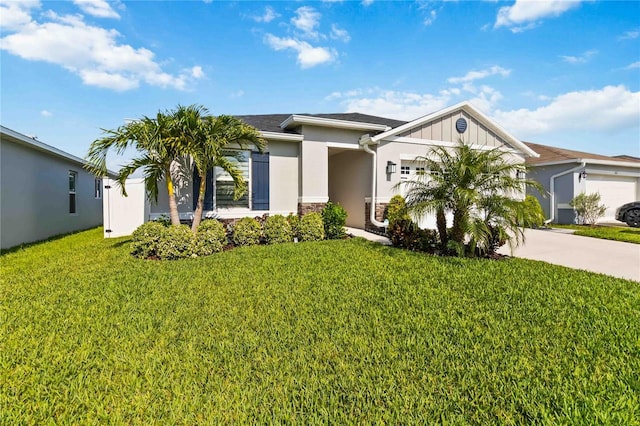 3211 Sweet Acres Pl, Saint Cloud, FL 34772 - view of front of home featuring concrete driveway, a garage, a front yard, stucco siding, and stone siding
