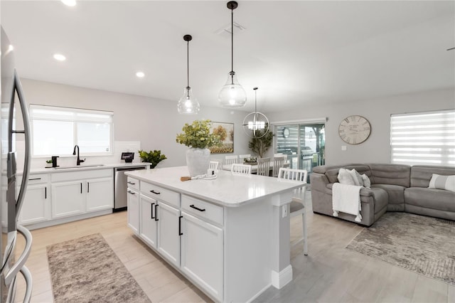 3211 Sweet Acres Pl, Saint Cloud, FL 34772 - kitchen with stainless steel appliances, a sink, healthy amount of natural light, white cabinetry, and recessed lighting