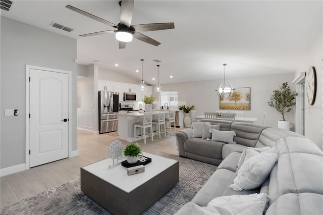 3211 Sweet Acres Pl, Saint Cloud, FL 34772 - living room featuring light wood-style flooring, a ceiling fan, lofted ceiling, recessed lighting, and a chandelier