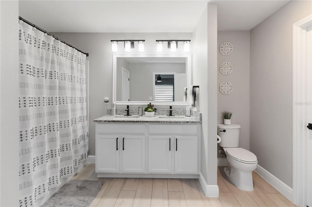 3211 Sweet Acres Pl, Saint Cloud, FL 34772 - bathroom with toilet, double vanity, baseboards, and a shower with shower curtain