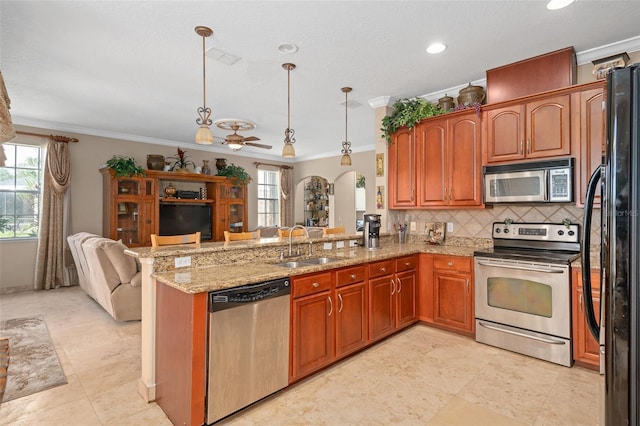 15037 Cedar Branch Way, Orlando, FL 32824 - kitchen with appliances with stainless steel finishes, open floor plan, a sink, a peninsula, and crown molding