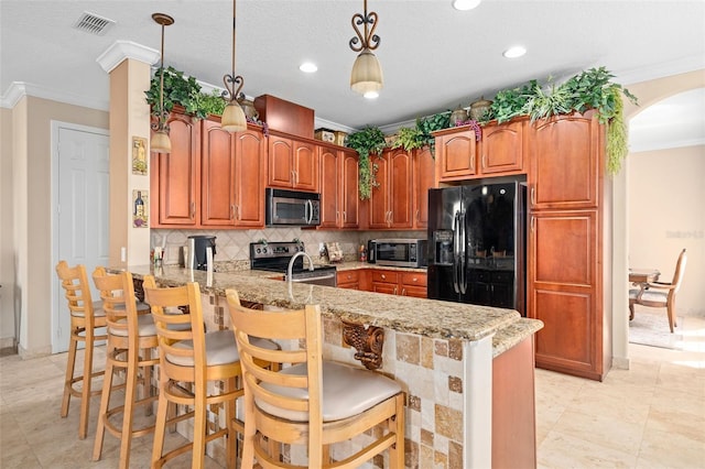 15037 Cedar Branch Way, Orlando, FL 32824 - kitchen featuring appliances with stainless steel finishes, crown molding, a peninsula, light stone counters, and tasteful backsplash
