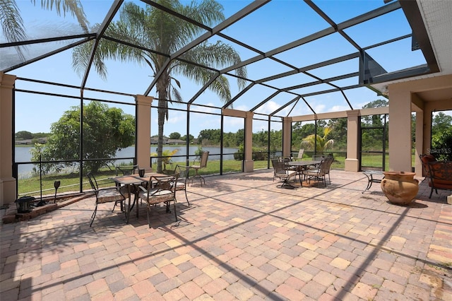 15037 Cedar Branch Way, Orlando, FL 32824 - view of patio with outdoor dining space, a lanai, and a water view