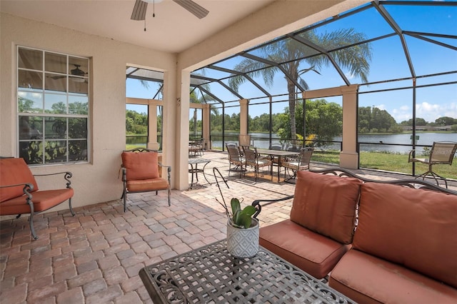 15037 Cedar Branch Way, Orlando, FL 32824 - view of patio / terrace with a water view, a ceiling fan, glass enclosure, outdoor dining space, and view of scattered trees
