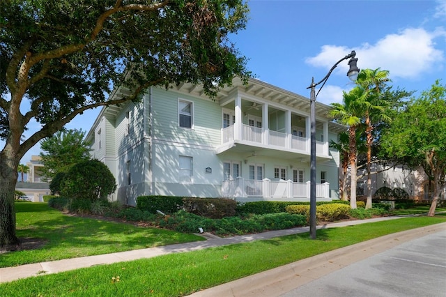 7468 Excitement Dr Unit 101, Reunion, FL 34747 - view of front facade with a balcony, a front yard, and ceiling fan