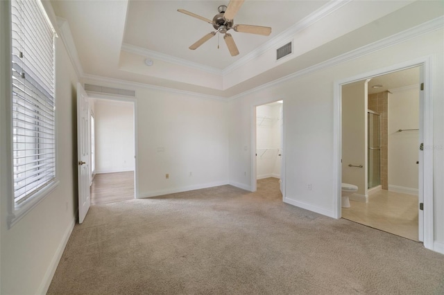 7468 Excitement Dr Unit 101, Reunion, FL 34747 - unfurnished bedroom featuring light carpet, a walk in closet, crown molding, a closet, and ensuite bathroom