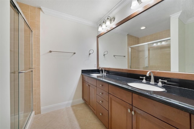 7468 Excitement Dr Unit 101, Reunion, FL 34747 - bathroom featuring ornamental molding, double vanity, tiled shower, tile patterned floors, and baseboards
