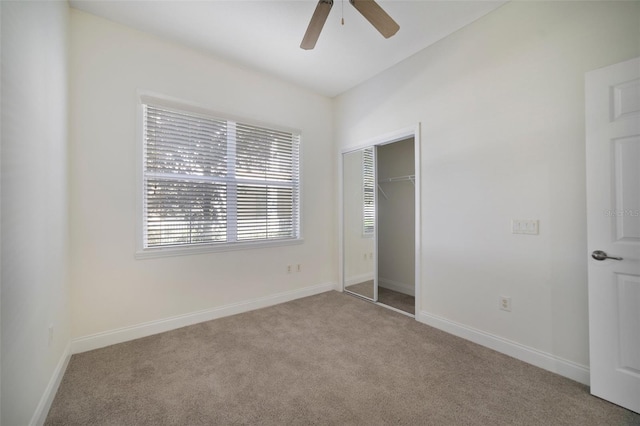 7468 Excitement Dr Unit 101, Reunion, FL 34747 - unfurnished bedroom featuring multiple windows, carpet, a closet, and baseboards