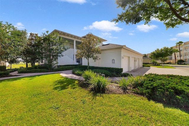 7468 Excitement Dr Unit 101, Reunion, FL 34747 - view of front of home featuring stucco siding, a front yard, concrete driveway, and a garage