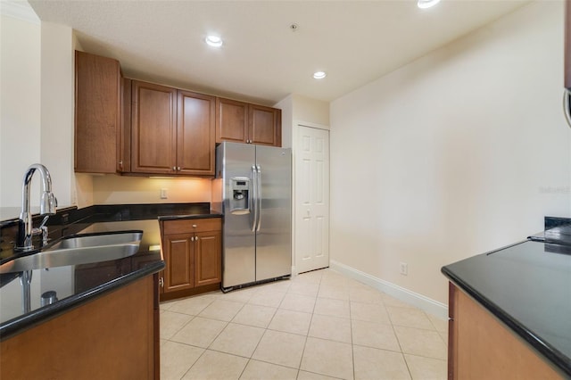1501 Northern Harrier Way Unit 202, Reunion, FL 34747 - kitchen featuring stainless steel fridge with ice dispenser, a sink, recessed lighting, brown cabinetry, and baseboards
