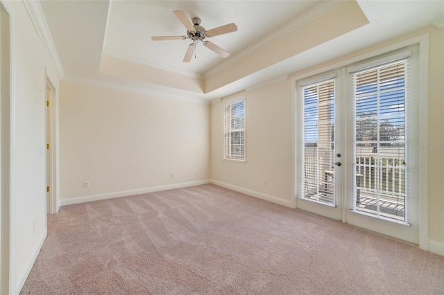 1501 Northern Harrier Way Unit 202, Reunion, FL 34747 - empty room featuring a raised ceiling, ornamental molding, light carpet, a ceiling fan, and baseboards