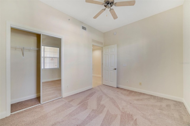 1501 Northern Harrier Way Unit 202, Reunion, FL 34747 - unfurnished bedroom featuring light colored carpet, a closet, baseboards, and a ceiling fan