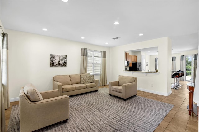 341 Lasso Dr, Kissimmee, FL 34747 - living area with light tile patterned flooring, recessed lighting, and baseboards