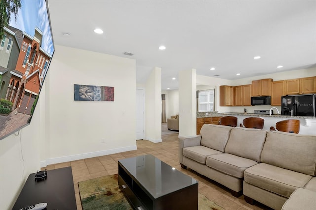 341 Lasso Dr, Kissimmee, FL 34747 - living room with recessed lighting, baseboards, and light tile patterned flooring