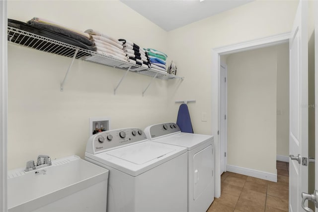 341 Lasso Dr, Kissimmee, FL 34747 - laundry area featuring washing machine and dryer, baseboards, and light tile patterned floors