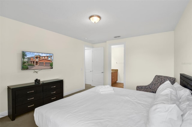 341 Lasso Dr, Kissimmee, FL 34747 - bedroom with baseboards and ensuite bath