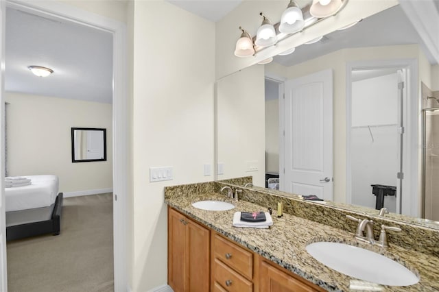 341 Lasso Dr, Kissimmee, FL 34747 - ensuite bathroom with double vanity and baseboards
