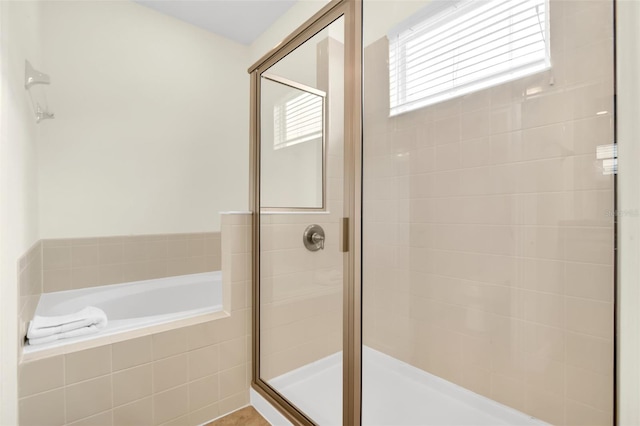 341 Lasso Dr, Kissimmee, FL 34747 - full bathroom with a stall shower, a bath, and healthy amount of natural light