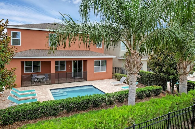341 Lasso Dr, Kissimmee, FL 34747 - back of house featuring stucco siding, a patio area, and roof with shingles