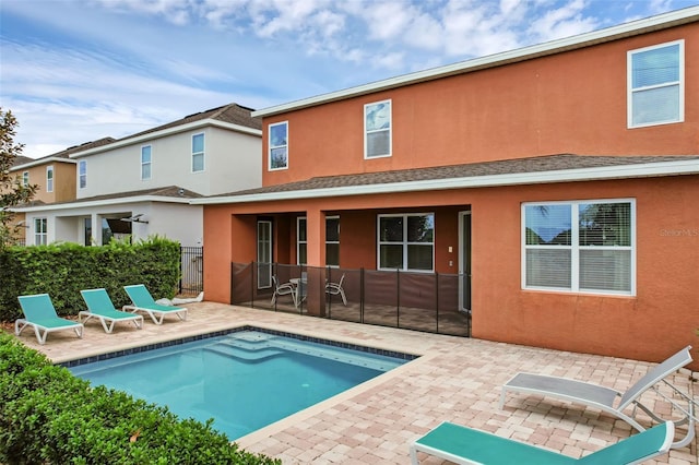341 Lasso Dr, Kissimmee, FL 34747 - back of property featuring a patio area, stucco siding, and roof with shingles