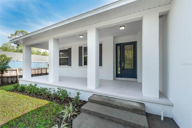 6479 Apple St, Saint Cloud, FL 34771 - view of exterior entry featuring a porch and stucco siding