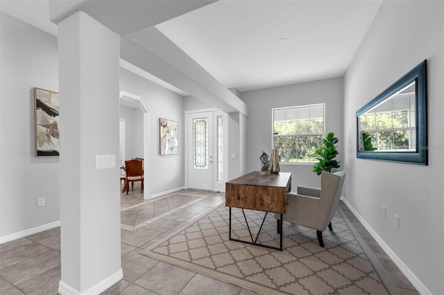 6479 Apple St, Saint Cloud, FL 34771 - home office featuring arched walkways, baseboards, and tile patterned floors