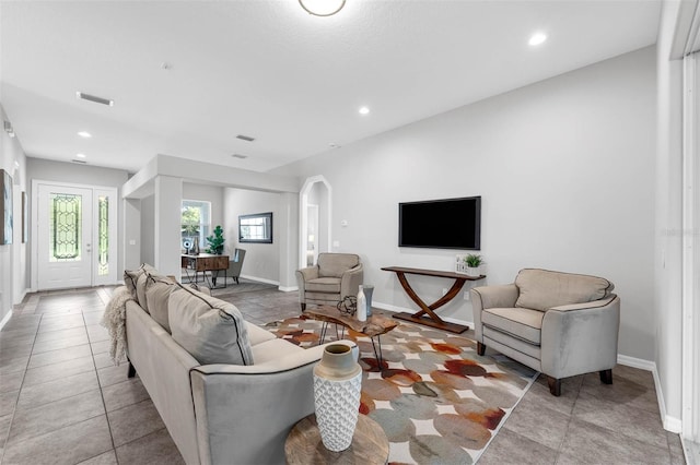 6479 Apple St, Saint Cloud, FL 34771 - tiled living room featuring baseboards, arched walkways, and recessed lighting