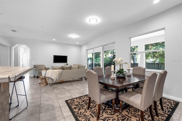 6479 Apple St, Saint Cloud, FL 34771 - dining area featuring arched walkways, light tile patterned floors, recessed lighting, and baseboards