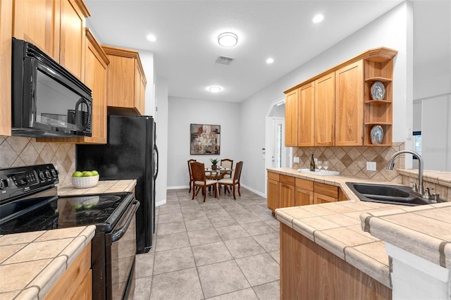 6479 Apple St, Saint Cloud, FL 34771 - kitchen with black appliances, a sink, tile counters, open shelves, and tasteful backsplash