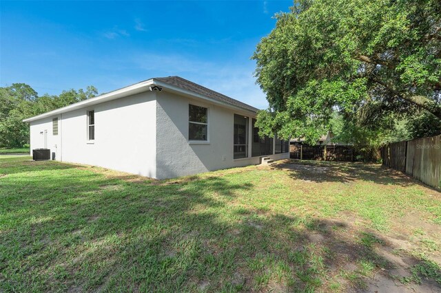 6479 Apple St, Saint Cloud, FL 34771 - view of home's exterior featuring stucco siding, cooling unit, and a sunroom