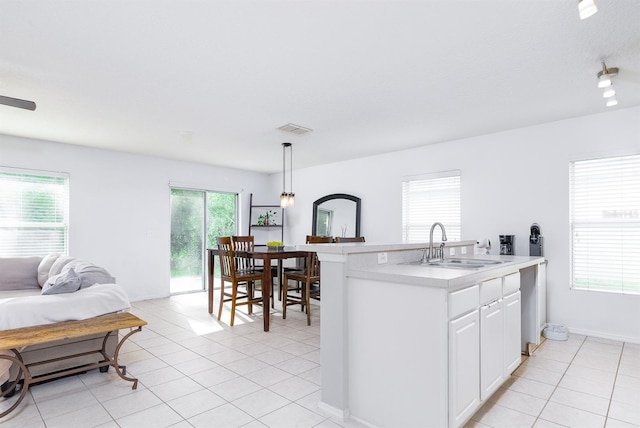 56 Levee Ln, Ormond Beach, FL 32174 - kitchen with light countertops, light tile patterned floors, white cabinets, pendant lighting, and open floor plan