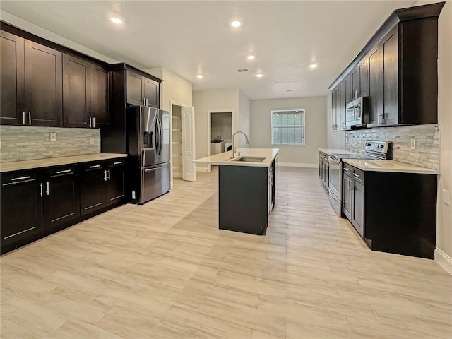 2164 Crosston Cir, Orlando, FL 32824 - kitchen with stainless steel appliances, a sink, baseboards, backsplash, and light countertops