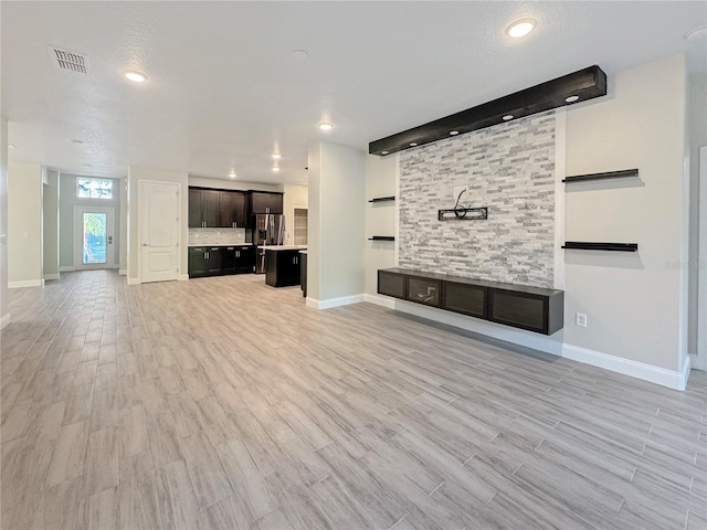 2164 Crosston Cir, Orlando, FL 32824 - unfurnished living room with baseboards, light wood-type flooring, and recessed lighting