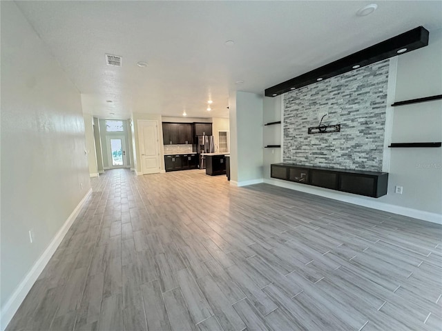 2164 Crosston Cir, Orlando, FL 32824 - unfurnished living room with wood finished floors, baseboards, and built in features