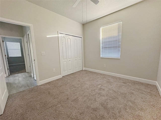 2164 Crosston Cir, Orlando, FL 32824 - unfurnished bedroom with carpet flooring, a textured ceiling, a closet, baseboards, and a ceiling fan
