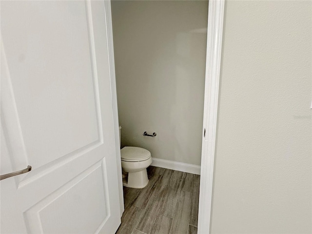 2164 Crosston Cir, Orlando, FL 32824 - bathroom featuring toilet, wood finished floors, and baseboards