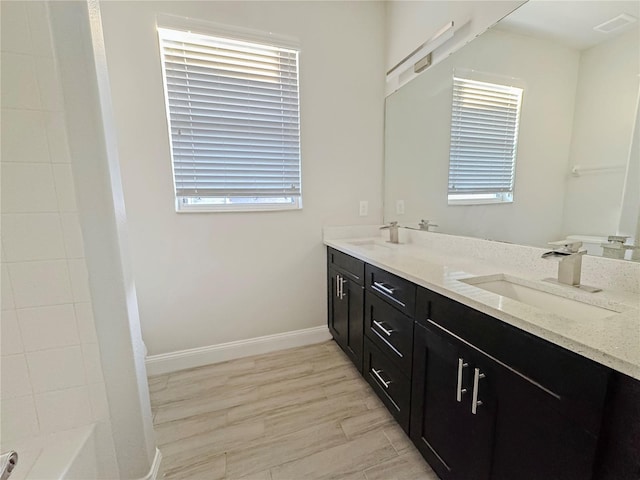 2164 Crosston Cir, Orlando, FL 32824 - bathroom with double vanity, baseboards, and shower / washtub combination