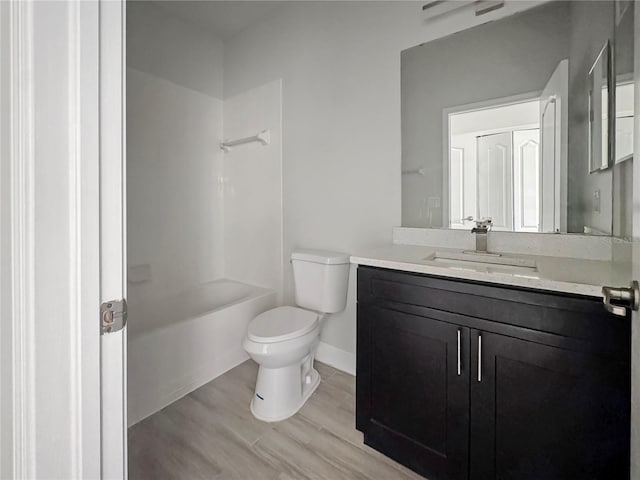 2164 Crosston Cir, Orlando, FL 32824 - full bathroom featuring toilet, vanity, wood finished floors, shower / bath combination, and baseboards