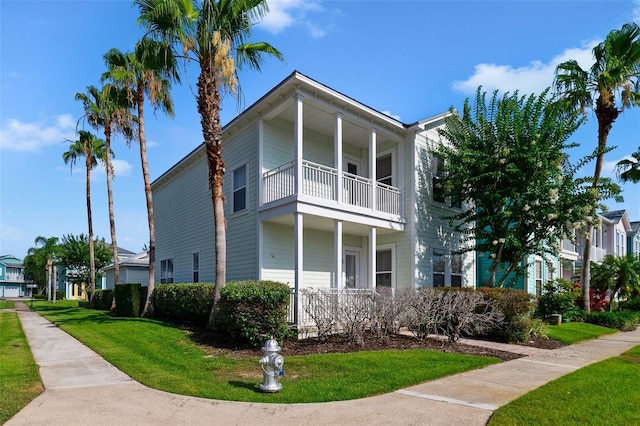 7740 Linkside Loop, Reunion, FL 34747 - view of side of home featuring a balcony and a yard