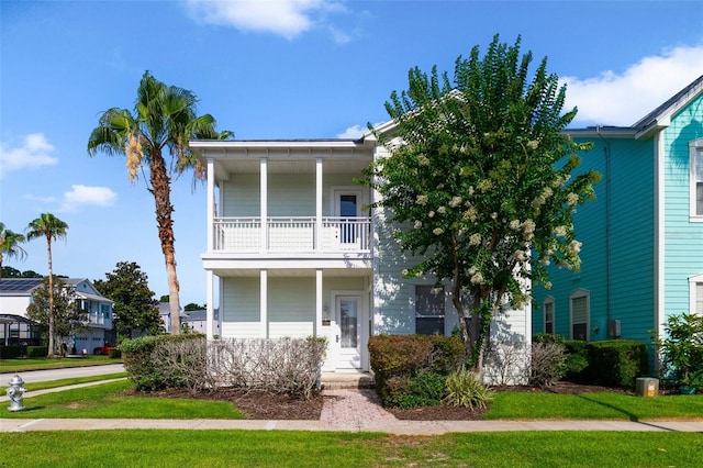 7740 Linkside Loop, Reunion, FL 34747 - view of front of home with a balcony and a front yard